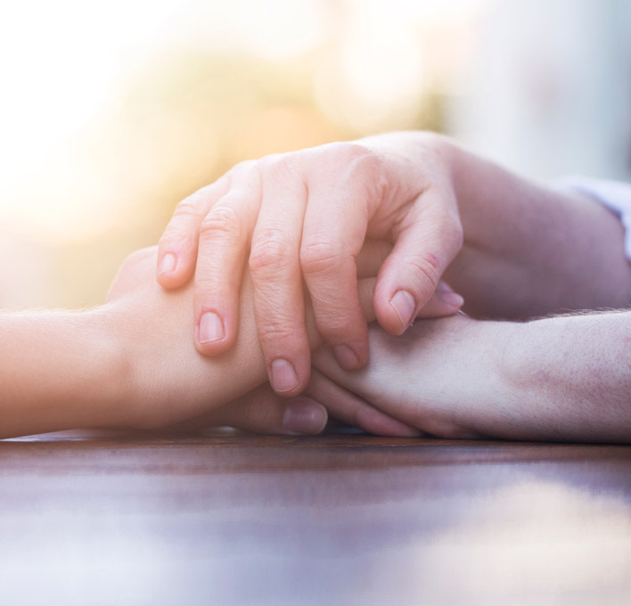 Two people holding hands